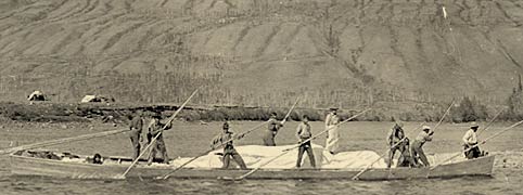 ...poling a scow on the Pelly River near Ross River in July, 1923.