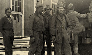 A group of black men behind and boarding truck in winter