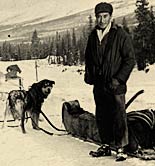 Walter Fox standing beside his dog team