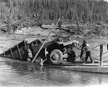 truck being winched out of a river