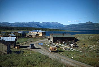 Burwash Landing, Kluane Lake with cars and log buildings visible. 1948.