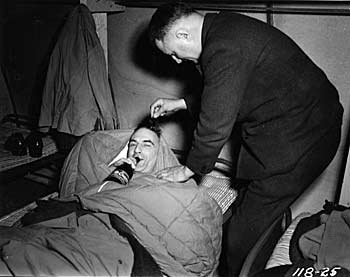 Drinking beer in bed. ca. 1944.