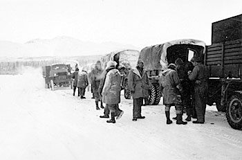 soldiers linger around a truck convoy 