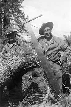 Soldiers posing with a hand saw
