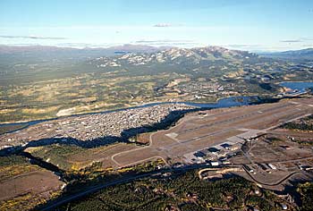 Aerial view of Whitehorse airport with downtown Whitehorse in the background.